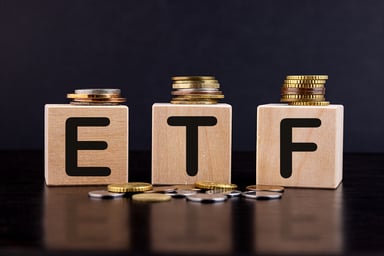 Blocks with the letters E, T, and F on them with gold and silver coins around it.