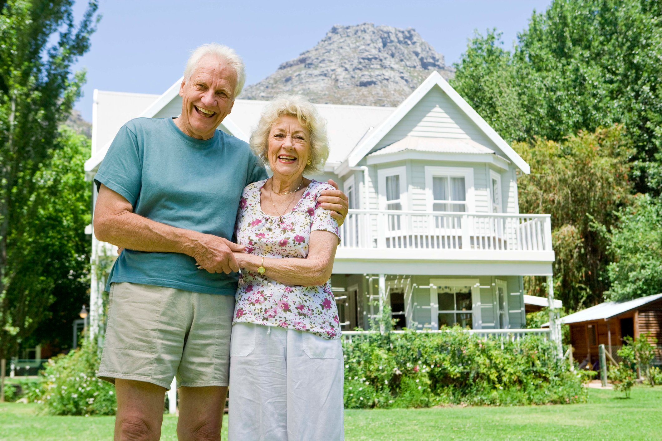 senior couple outside of larger home GettyImages-89794602