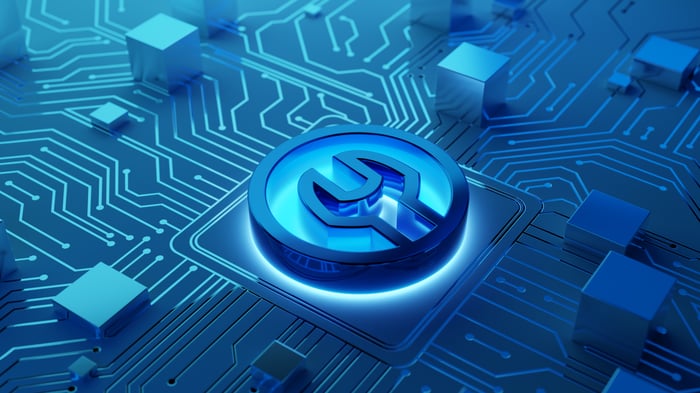 A wrench sits in a computer board. 