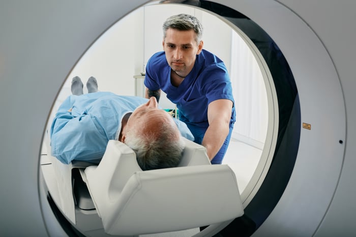 A scan technologist preparing a patient for a CT scan.