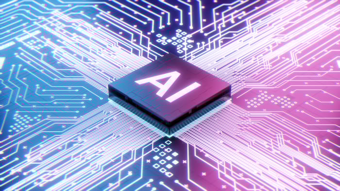 A bright colored rendering of a chip labeled AI in a computer circuit.