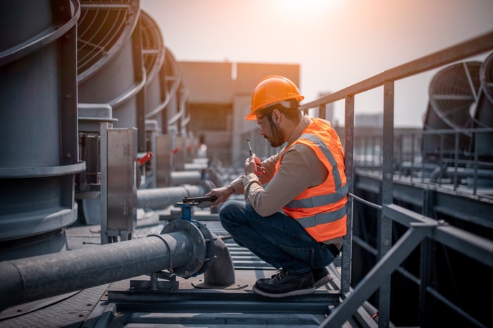 A technician working on an air conditioning system. 