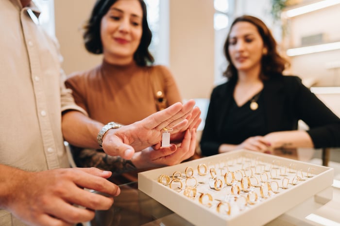Two women looking at rings in a store.
