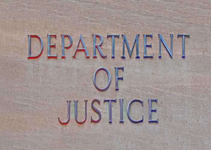Department of Justice sign on the side of the building. 