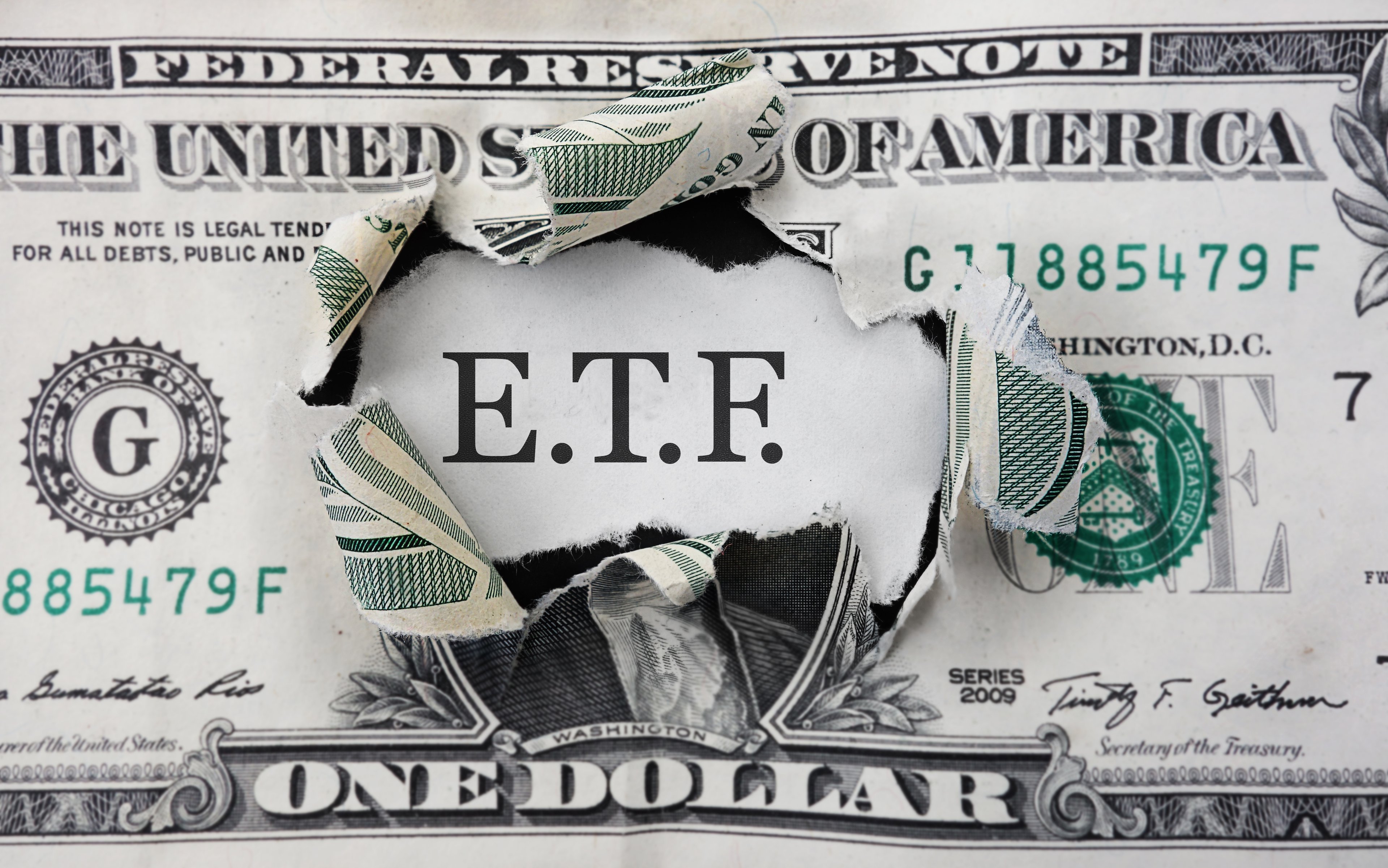 ETF bursting through a dollar bill