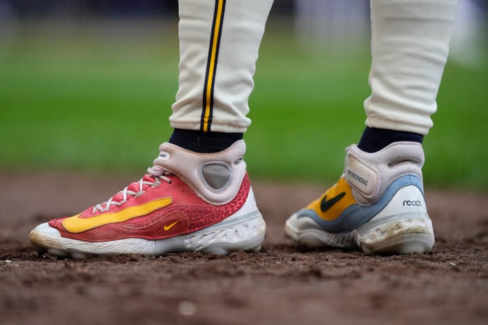 Baseball player wearing Nike shoes.