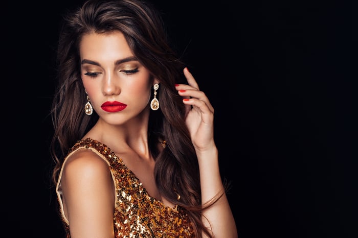 A person wearing gold jewelry. 