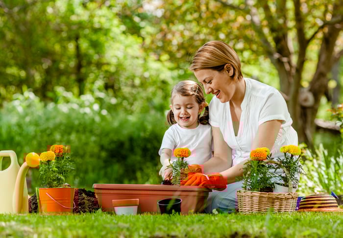 Two people planting flowers in April