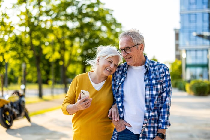 Smiling couple walking down the street together.