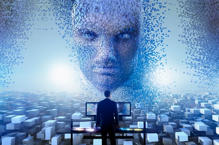 AI face looming over a man at a computer screen.
