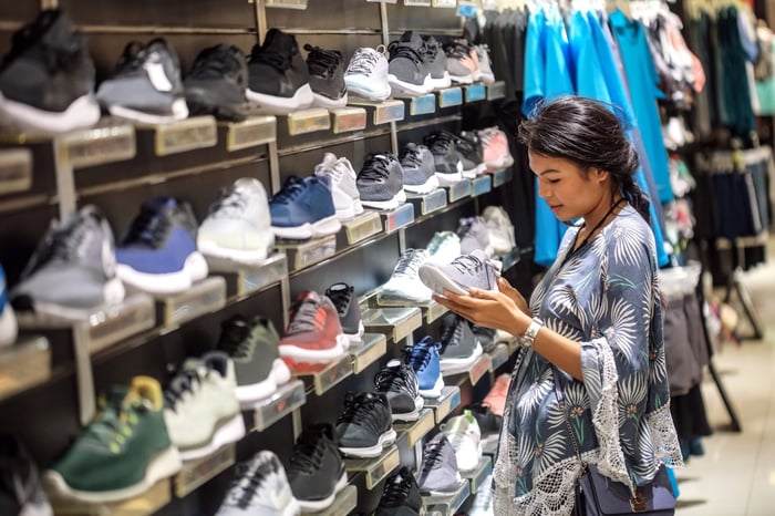 Person looking at shoes in a store.