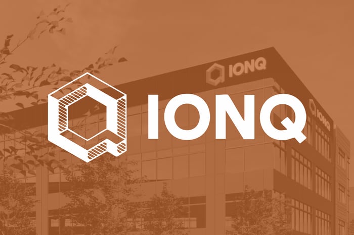 The IonQ logo superimposed over an image of an IonQ building. 