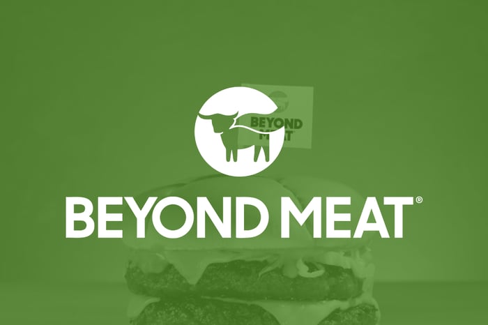Beyond Meat logo on top of a shadowy green background.