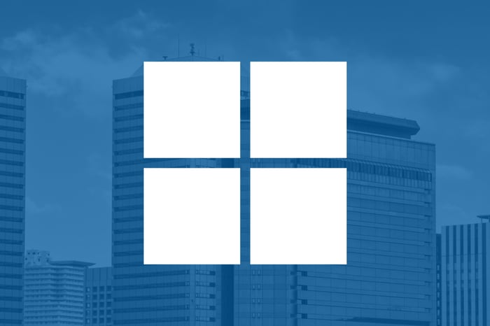 Microsoft's logo overlaid on a shadowy blue background.