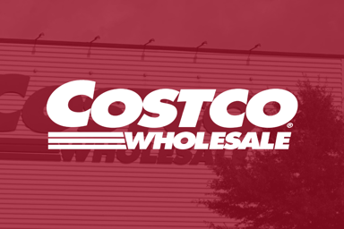 Costco logo on red filter with signage in background_The Motley Fool