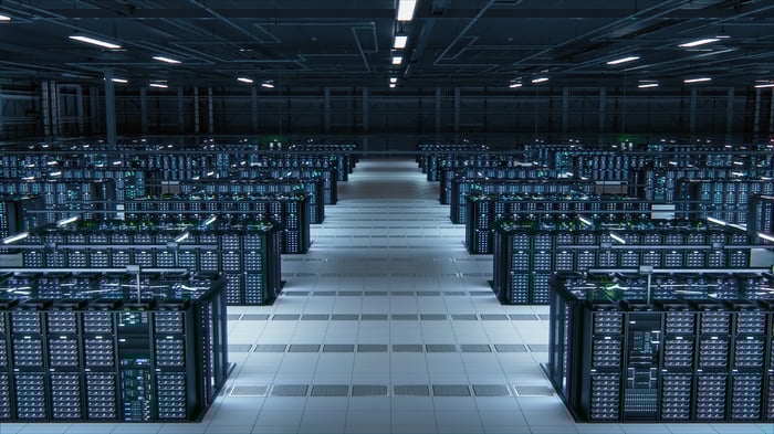 Rows of server racks in a large data center. 