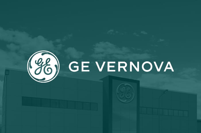 GE Vernova logo in white set over company headquarters shaded in green. 