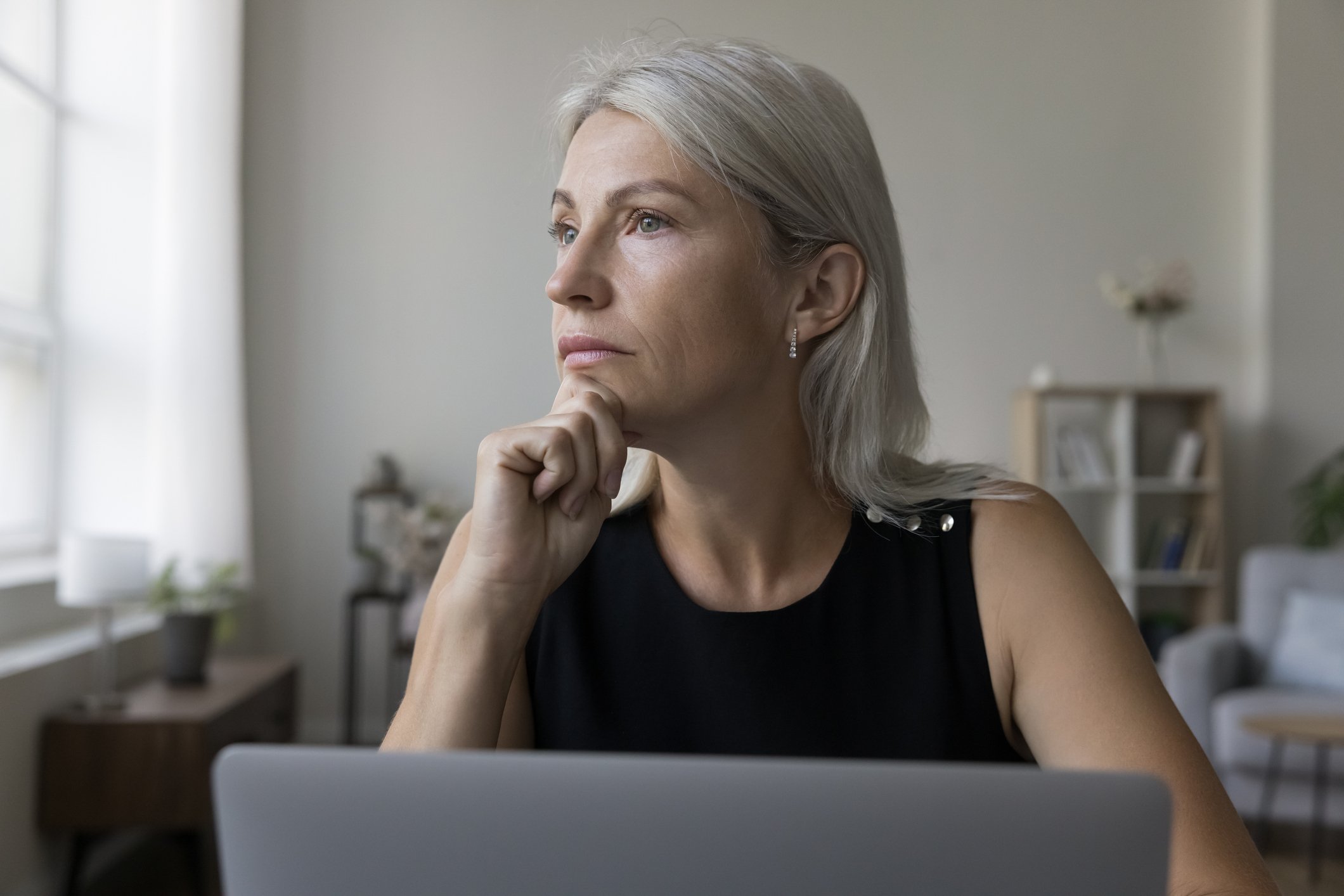 Older woman laptop thoughtful GettyImages-1578882963