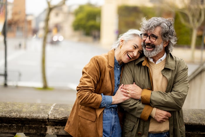 An older couple walk together.