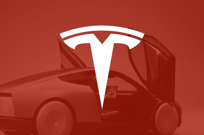The Tesla logo on a transparent red background that shows a Cybercab.