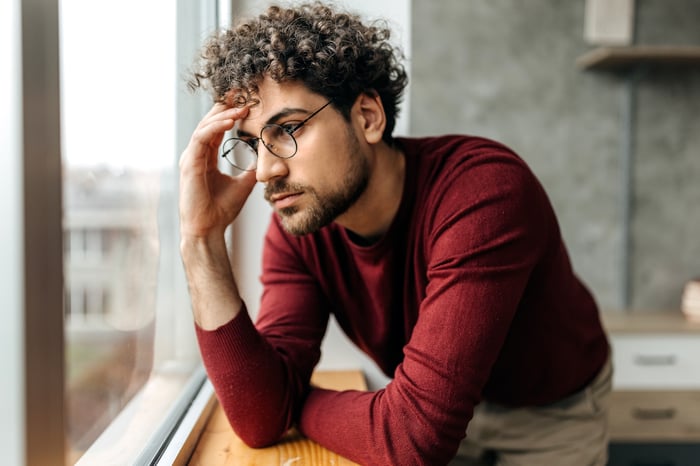 person staring out window dealing with depression.