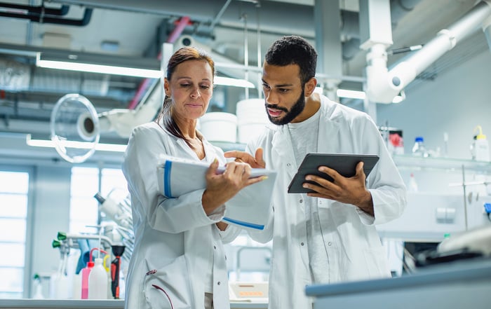 Two cancer scientists working together in a lab.