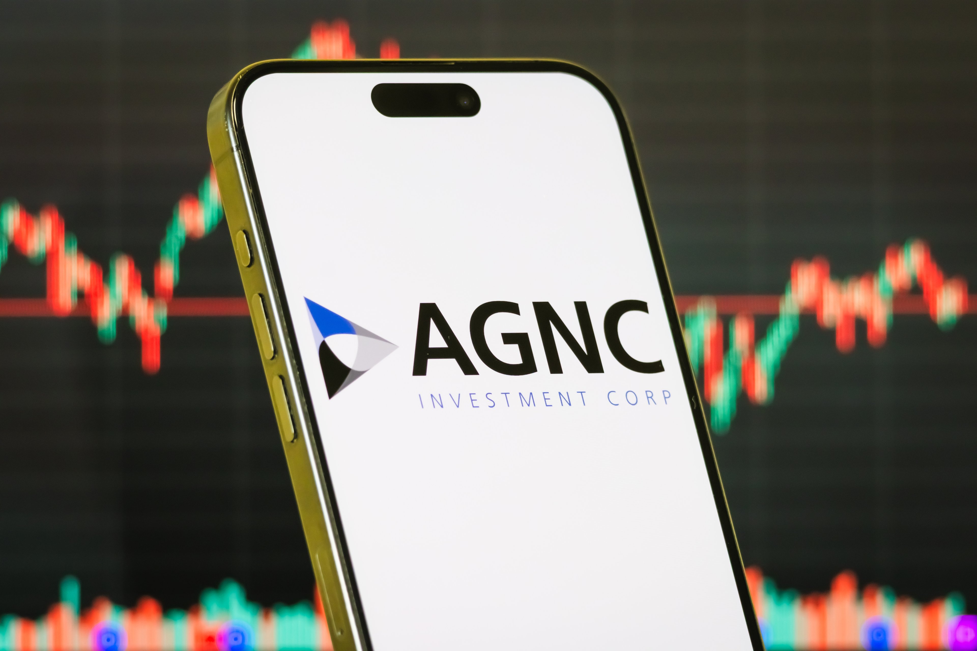agnc investment corp logo on smartphone with stock chart background-AGNC