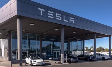 tesla sales building with tesla logo and teslas parked in front (2)