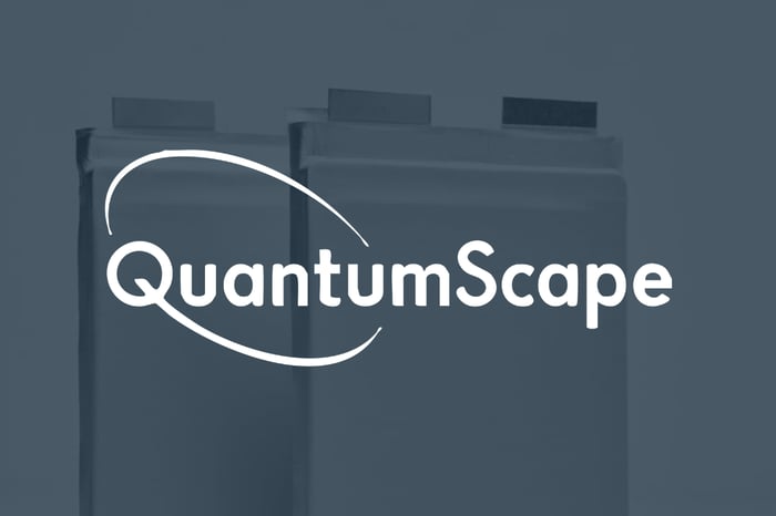 White QuantumScape logo set over shadow picture of its battery cells.