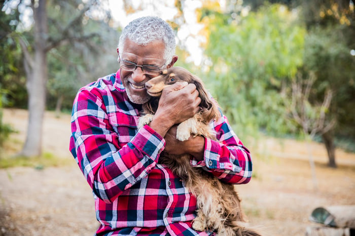 Person holding a dog.