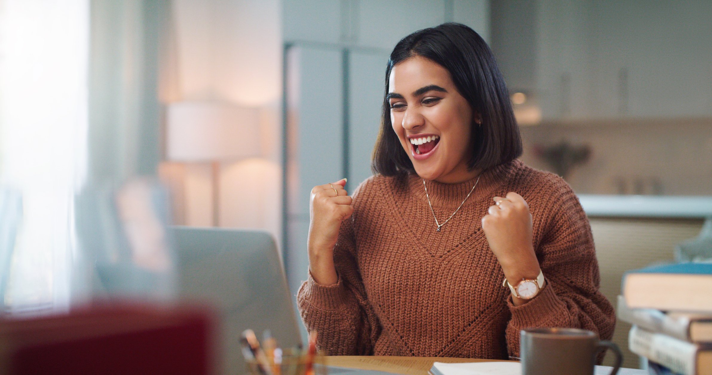 Getty - happy person at laptop success winning fists up victory yes