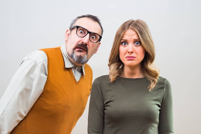 Two people looking shocked and worried.