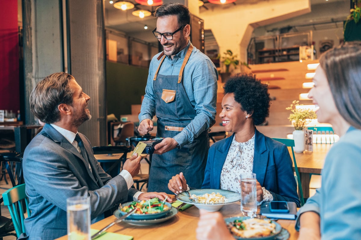 person makes card payment restaraunt getty