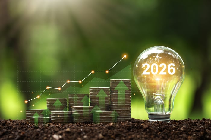 Rising stacks of coins with a light bulb saying "2026."