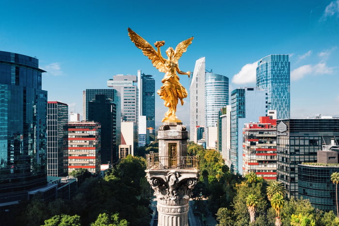 Golden angel statue atop a tower.