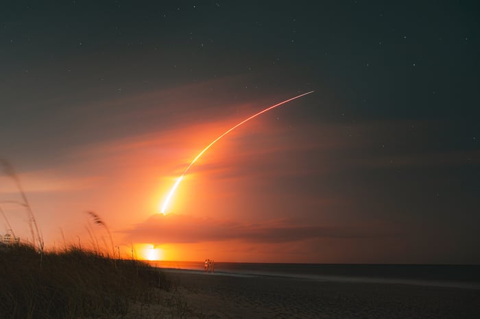 SpaceX Falcon 9 rocket trail on the beach.
