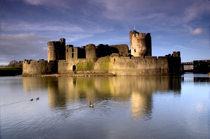 A castle is surrounded by a moat.
