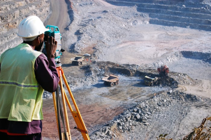 A surveyor looking out over an open mine.