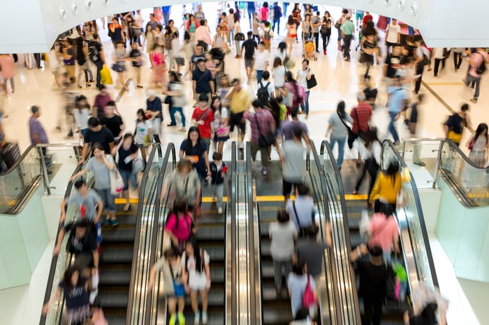 Shoppers pass through a busy mall in Asia.