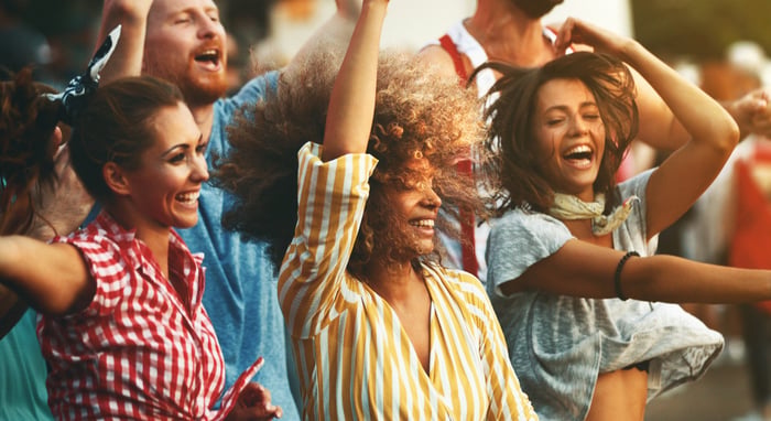 People are dancing at a concert. 