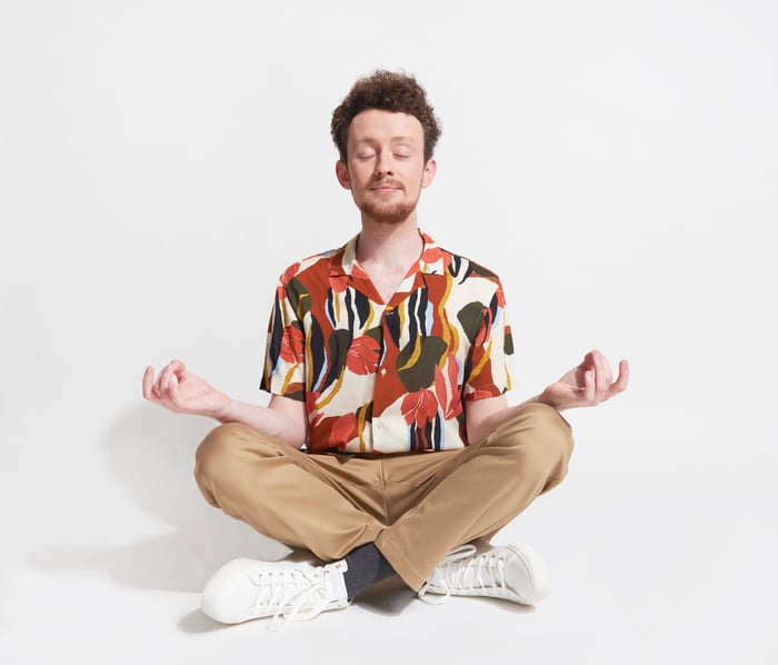 A person sitting cross-legged and meditating. 