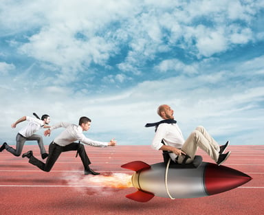 3 men racing in business attire one of them riding a rocket.