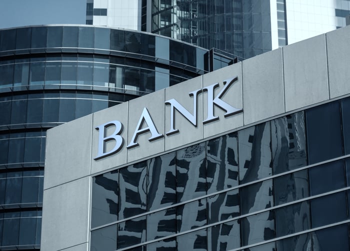A large, gray building with the word "Bank" on the exterior.