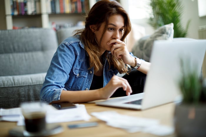 Worried investor looking at their laptop.