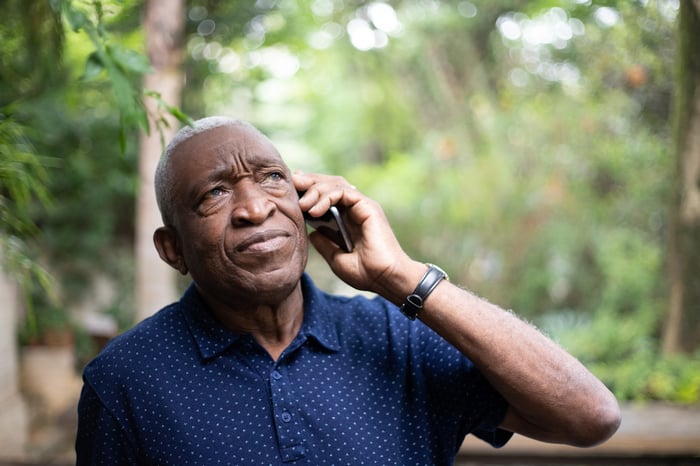 Confused person talking on phone.