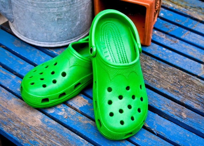 A pair of bright green Crocs shoes.