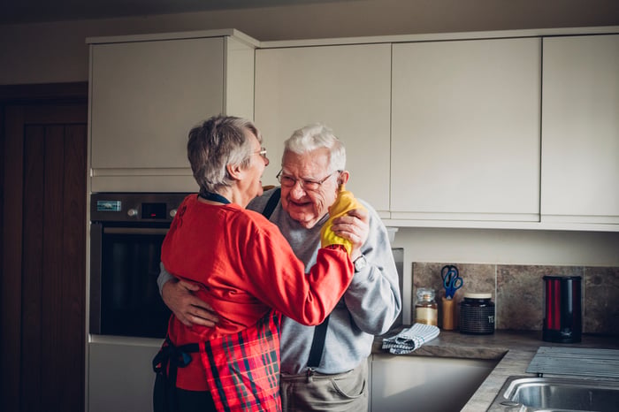 A couple dancing in the kitchen together.