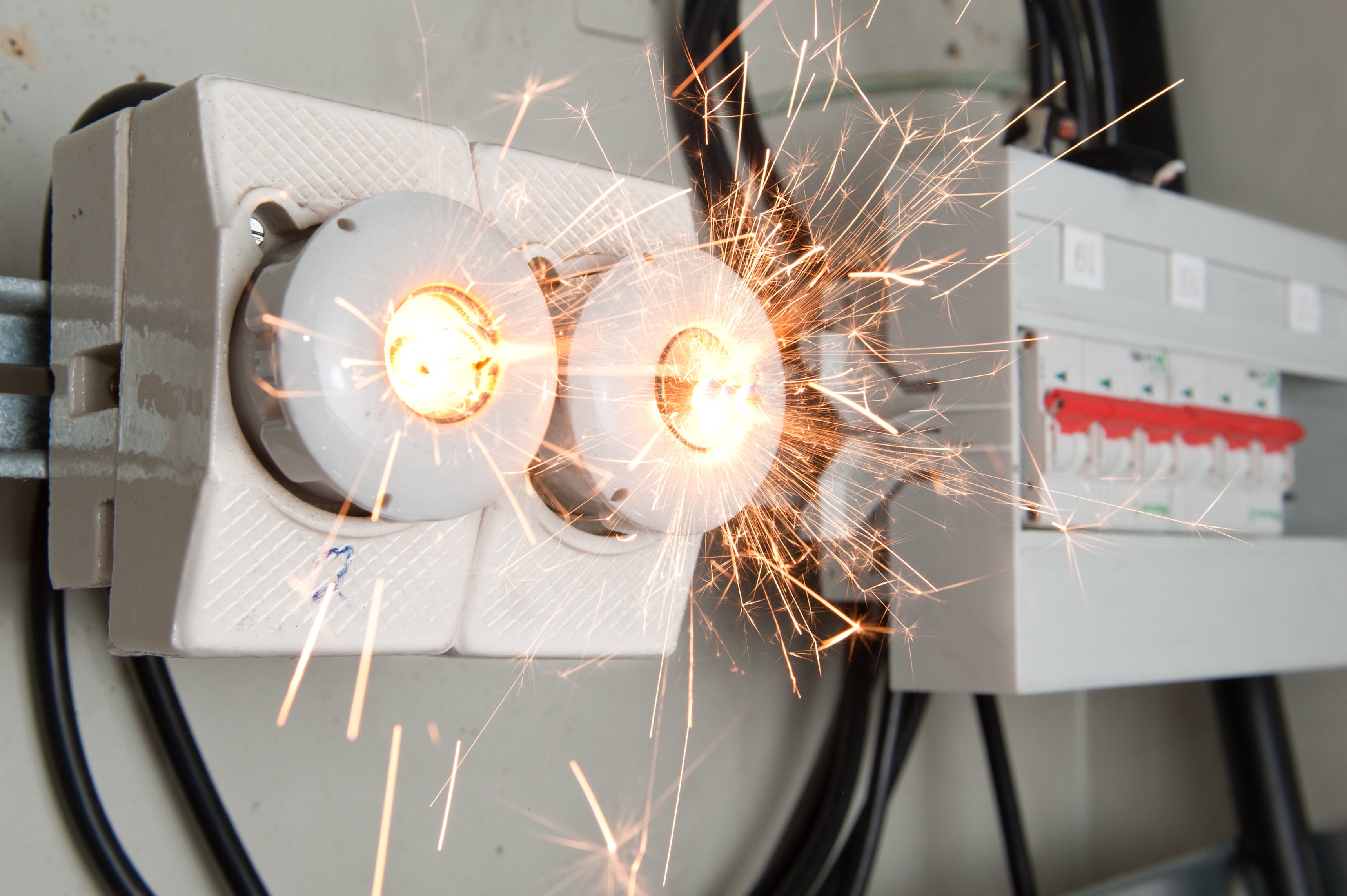 A short circuit in a fuse box throws sparks.