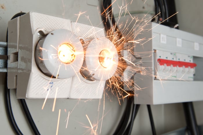 A short circuit in a fuse box throws sparks.