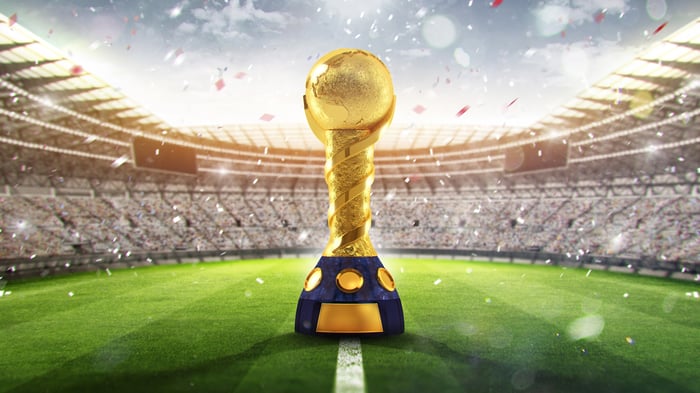 The World Cup trophy sitting in the middle of a stadium. 